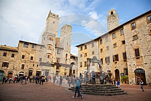 Towers and medieval well on Piazza della Cisterna in San Gimignano in tuscany in italy