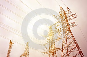 Towers power lines against a cloudy sky background. Electricity