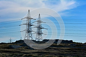 Towers of power lines in twilight