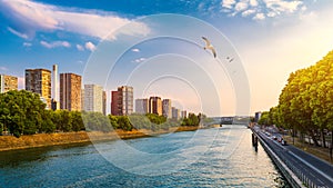 Towers and skyscrapers in Paris, France, used as office buildings as well as office buildings, by the water in front of barges on