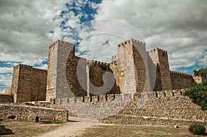 Towers and stone walls facade at the Castle of Trujillo