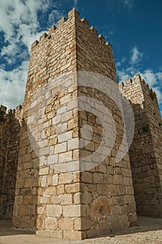 Towers and stone walls facade at the Castle of Trujillo