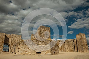 Towers and stone walls facade at the Castle of Trujillo