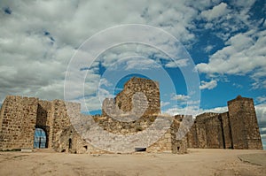 Towers and stone walls facade at the Castle of Trujillo