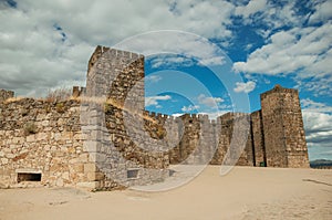 Towers and stone walls facade at the Castle of Trujillo