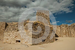 Towers and stone walls facade at the Castle of Trujillo