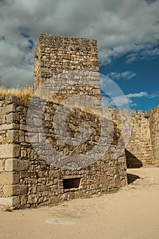 Towers and stone walls facade at the Castle of Trujillo