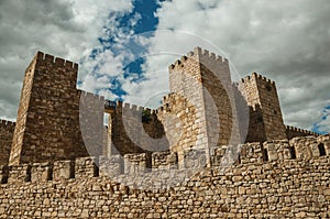 Towers and stone walls facade at the Castle of Trujillo