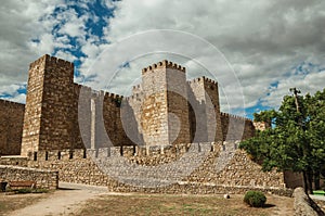 Towers and stone walls facade at the Castle of Trujillo