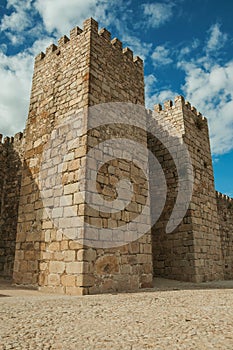 Towers and stone walls facade at the Castle of Trujillo