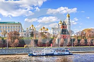 Towers and temples of the Kremlin and a pleasure ship on the Moskva River in Moscow