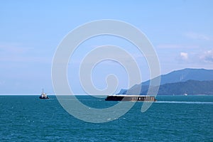 Towing boat or Cargo ship moving into the sea,Transportation and