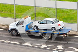 Towing service the tow truck with the loaded old damaged car which stopped working