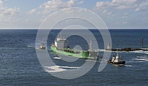 Towing ship to port at the mouth of Pasaia, Euskadi