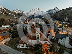 Town in the alps mountains during sunset.Aerial drone photo Blue Hour French alps in winter, Rhone Alpes in France Europe. Les