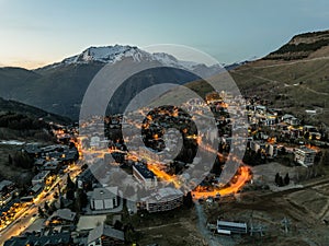 Town in the alps mountains during sunset.Aerial drone photo Blue Hour French alps in winter, Rhone Alpes in France Europe. Les