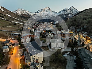 Town in the alps mountains during sunset.Aerial drone photo Blue Hour French alps in winter, Rhone Alpes in France Europe. Les