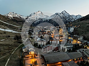 Town in the alps mountains during sunset.Aerial drone photo Blue Hour French alps in winter, Rhone Alpes in France Europe. Les