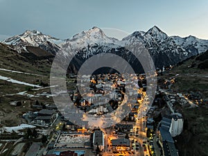 Town in the alps mountains during sunset.Aerial drone photo Blue Hour French alps in winter, Rhone Alpes in France Europe. Les