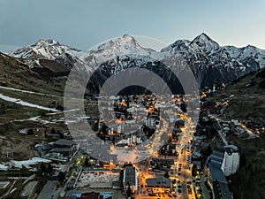 Town in the alps mountains during sunset.Aerial drone photo Blue Hour French alps in winter, Rhone Alpes in France Europe. Les