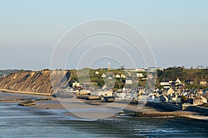 The town of Arromanches les Bains and its sandy beach in Europe, France, Normandy, in summer, on a sunny day