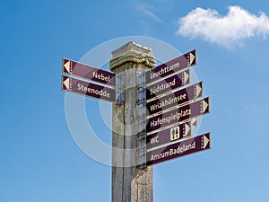 Town attractions signpost in Wittdun on Amrum island, North Frisia, Schleswig-Holstein, Germany