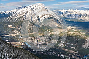 Town of Banff, Cascade Mountain and surrounding snow-covered Canadian Rocky Mountains in early winter time. Banff National Park