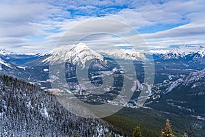 Town of Banff, Cascade Mountain and surrounding snow-covered Canadian Rocky Mountains in early winter time. Banff National Park