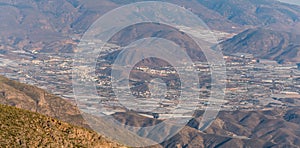 The town of Berja in Almeria surrounded by mountains and greenhouses photo