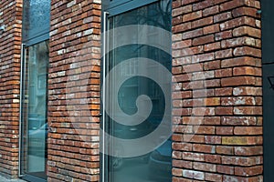 Town building, front door of red brick house with staircase.