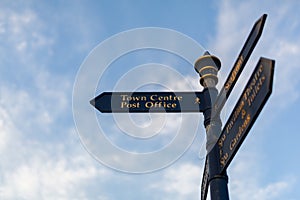 Town centre sign in a popular British seaside tourist destination, it is isolated against a blue sky with light clouds