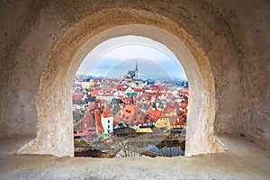 Town of Cesky Krumlov and Vltava river panoramic view through stone window