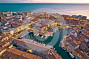 Town of Grado colorful architecture and waterfront aerial evening view