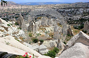 The town GÃ¶reme  with rock houses in front of the spectacularly coloured valleys nearby. Cappadocia, Central Anatolia, Turkey.