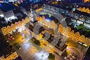 Town hall at the main square in old town of Jelenia Gora, Lower Silesia, Poland. Top down shot from drone at night