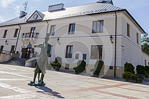 The town hall in Szczebrzeszyn with a famous sculpture of beetle playing on violin. Lublin Voivodship, Poland
