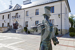 The town hall in Szczebrzeszyn with a famous sculpture of beetle playing on violin. Lublin Voivodship, Poland