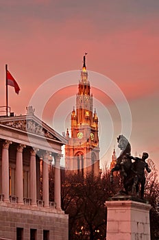 Town Hall Tower (The Rathaus) and the Parliament Building. Gorgeous sunset - landmark attraction in Vienna, Austria