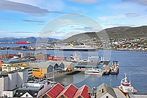 Town of Hammerfest with the downtown area, port, cruise ships & mountains in the background. Norway.