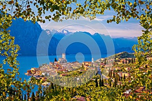 Town of Malcesine on Lago di Garda skyline viewthrough leaves fr