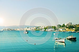 Town by the Mediterranean sea in turquoise lagoon, fishing boats in turquoise water on the clear sky background, summer landscape