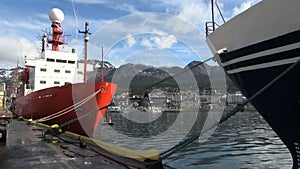 Town and mountains between docked ships