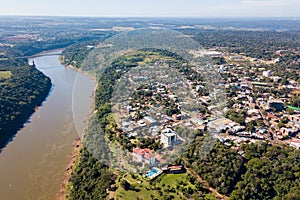 Town of Puerto Iguazu city centre aerial view. Fraternity Bridge border crossing Brazil-Argentina over the Iguassu River.