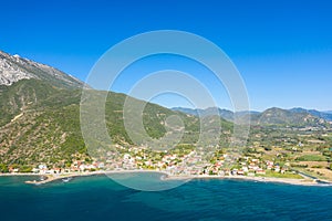 The town on the rocky coast in the middle of green countryside , Europe, Greece, Aetolia Acarnania, Kato Vasiliki towards Patras,