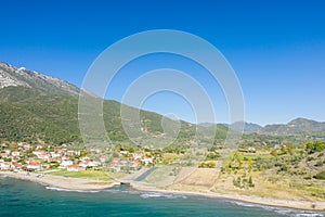 The town on the rocky coast in the middle of green countryside , Europe, Greece, Aetolia Acarnania, Kato Vasiliki towards Patras,