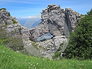 Town of Saillans viewed through Le Trou de la Laveuse Hole of the Washer