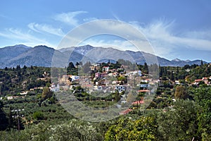 A town in the valley and rocky peaks in the Lefka Ori mountains on the island of Crete photo
