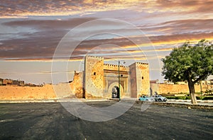 Town wall and gate Bab el-Khamis in medina of Meknes at sunset. Morocco photo