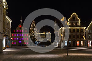 townhall and marketplace at advent christmas time evening