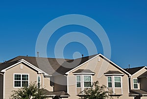 Townhome rooftops in the suburbs under a blue sky. photo